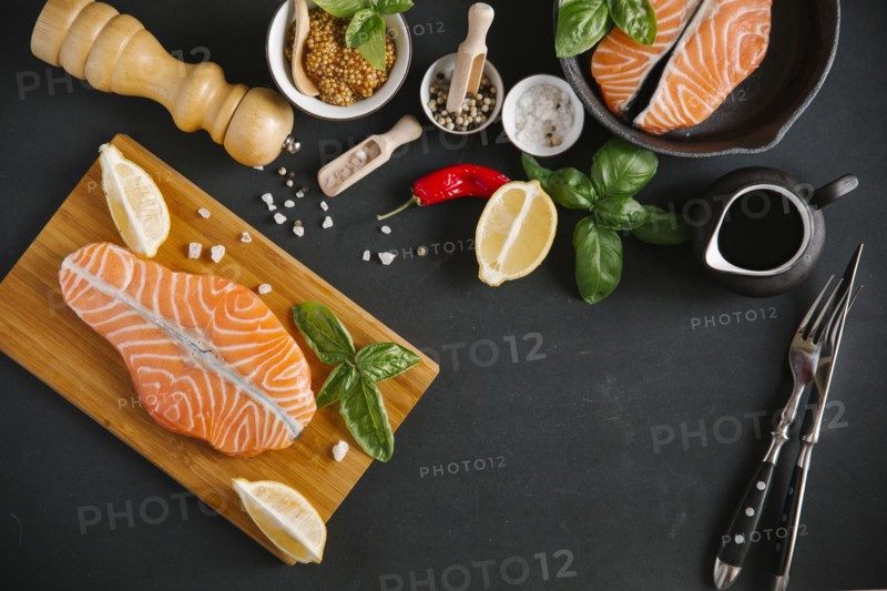 Raw salmon on cutting board with ingredients