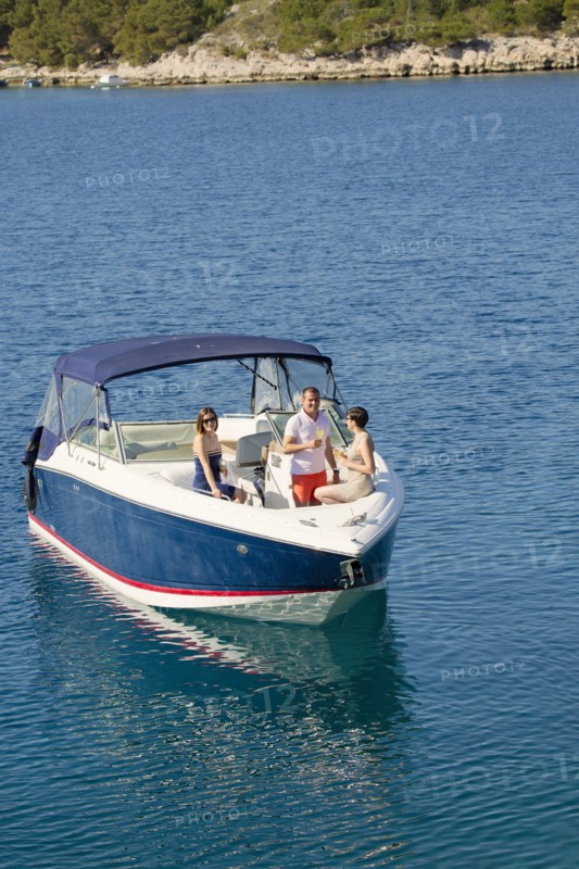 Friends relaxing on boat in ocean