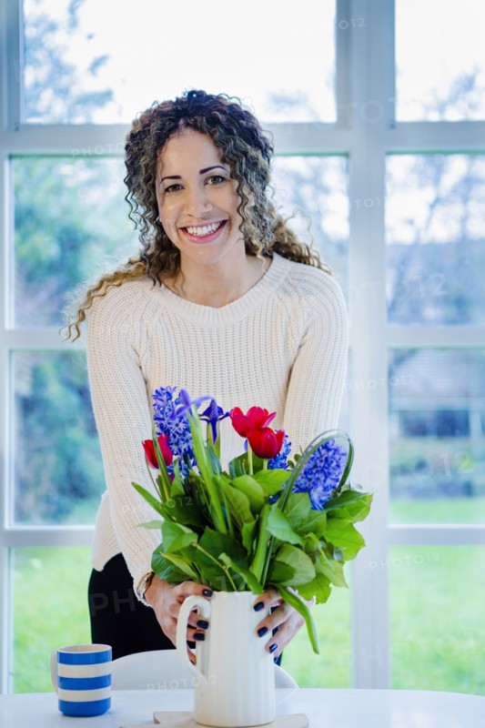 Woman holding vase with flowers