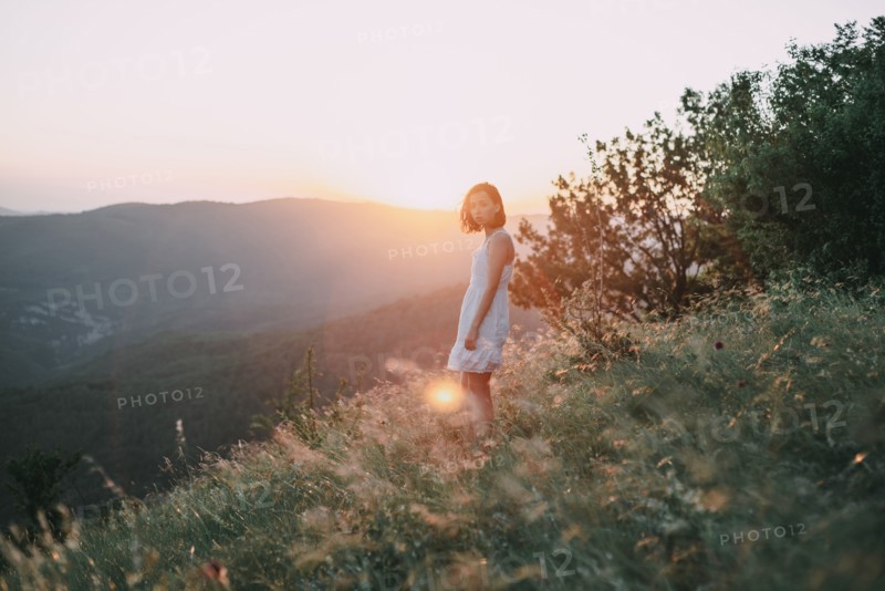 Serious Caucasian woman standing on mountain