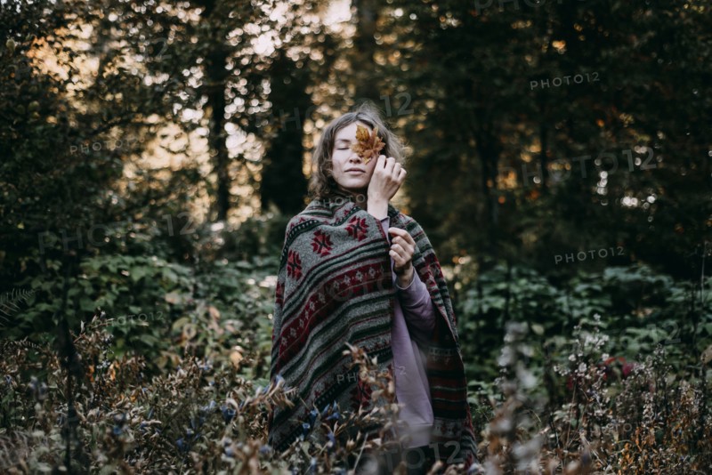 Caucasian woman holding autumn leaf