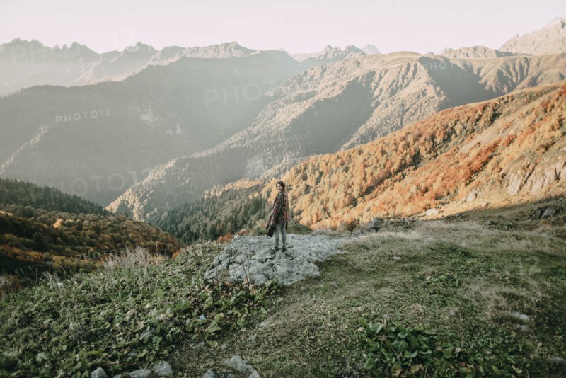 Caucasian woman smiling on mountain overlooking valley