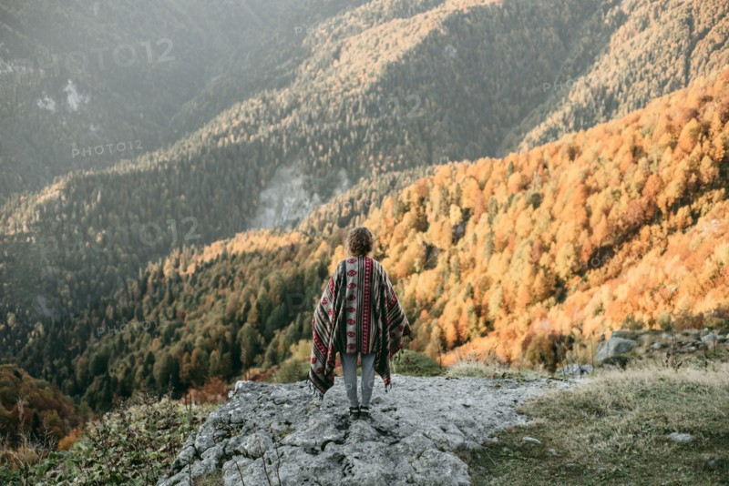 Caucasian woman standing on mountain overlooking valley