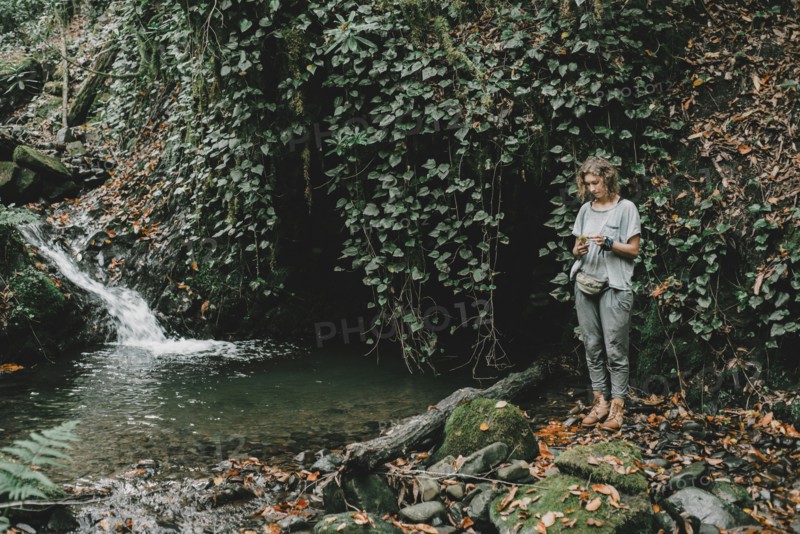 Caucasian woman standing near forest stream