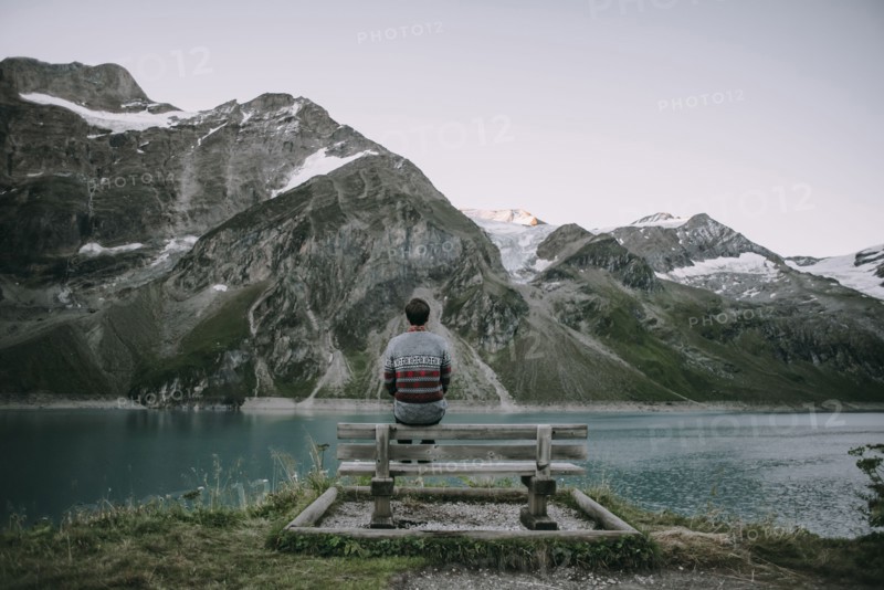 Caucasian man admiring scenic view of mountain lake