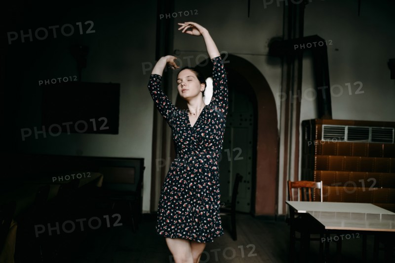 Caucasian woman dancing in livingroom
