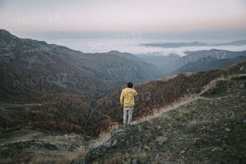 Caucasian man standing in remote mountain landscape