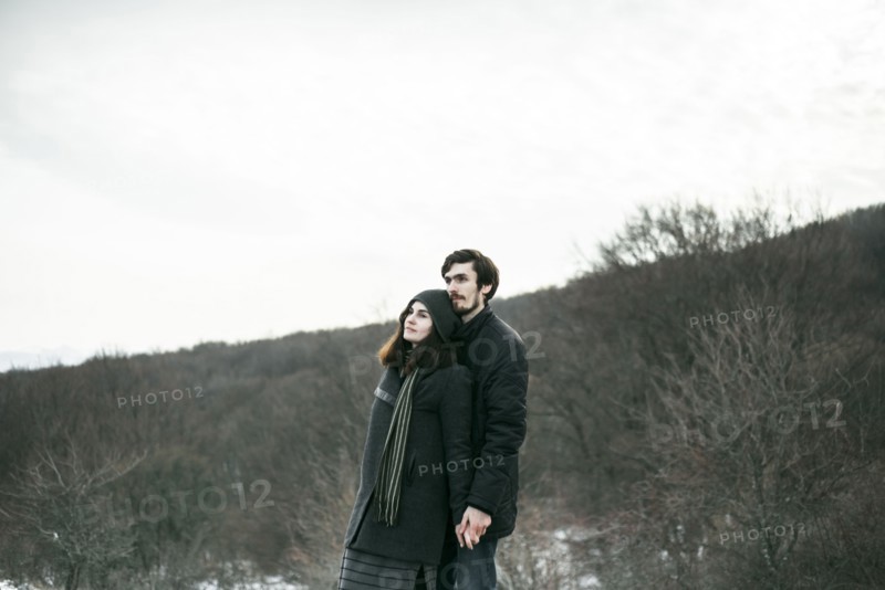 Caucasian couple standing on hill and relaxing