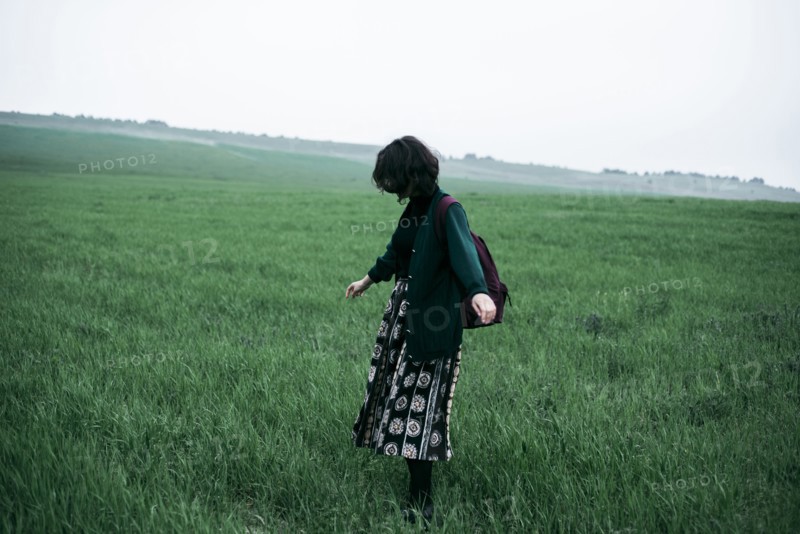 Caucasian woman standing in field of grass