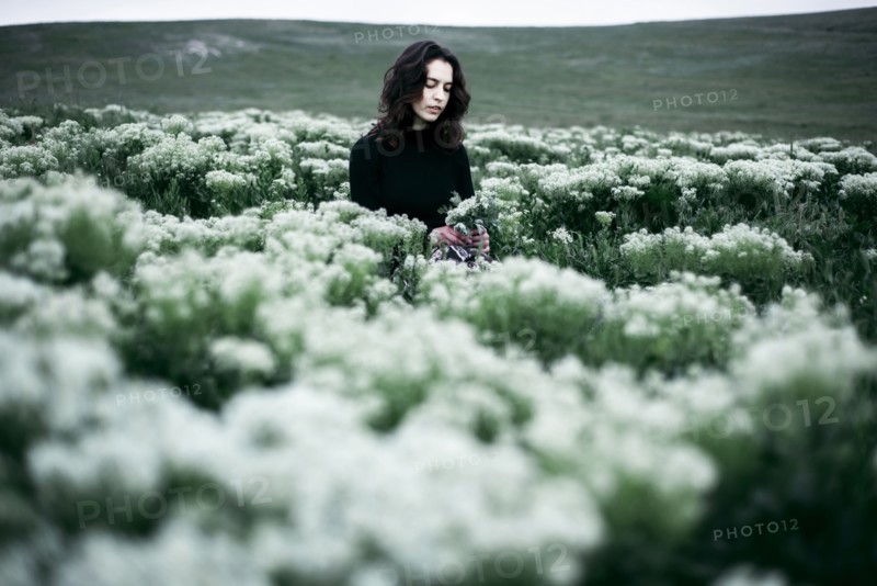 Caucasian woman standing in the field of wildflowers