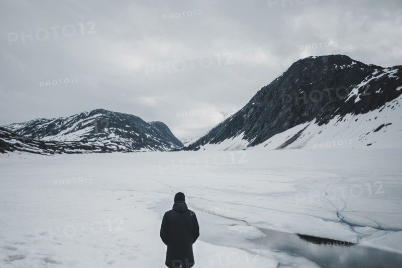 Caucasian man standing in mountain landscape in winter