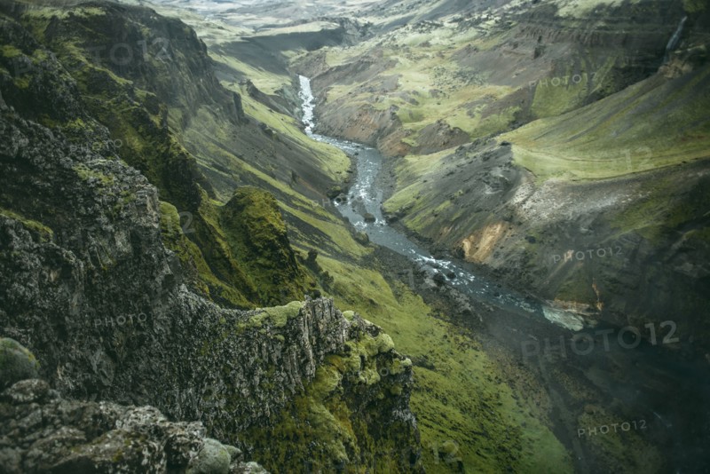 Scenic view of river in green valley