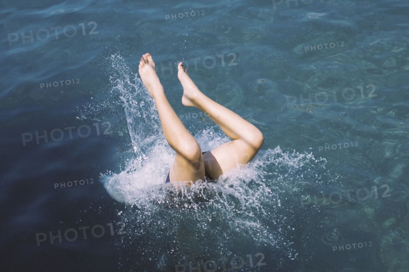 Caucasian teenage girl diving into water