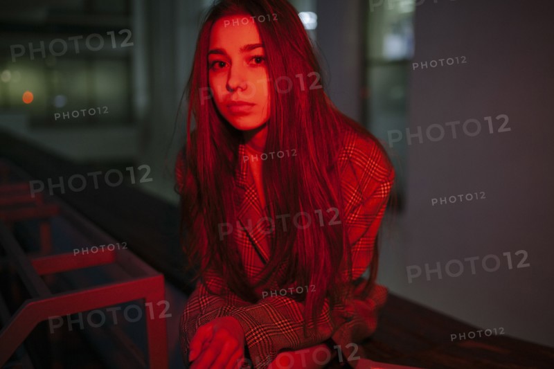 Serious Caucasian woman wearing jacket at night