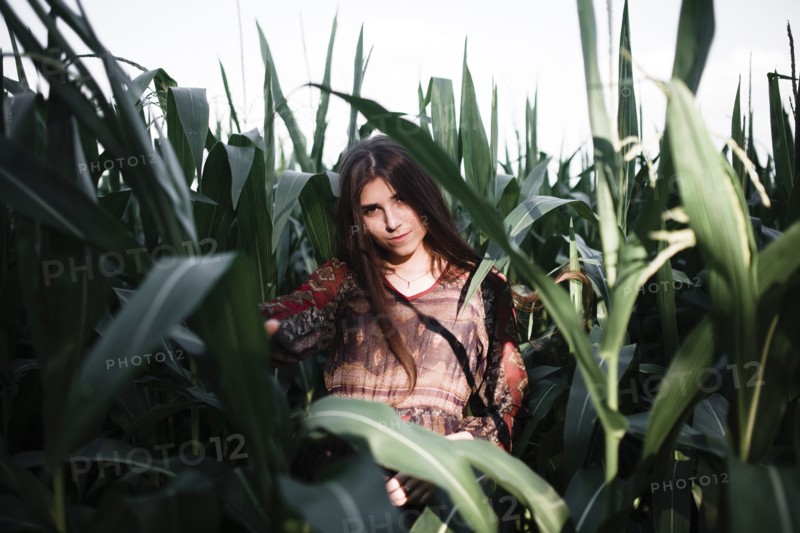 Caucasian woman standing in cornfield