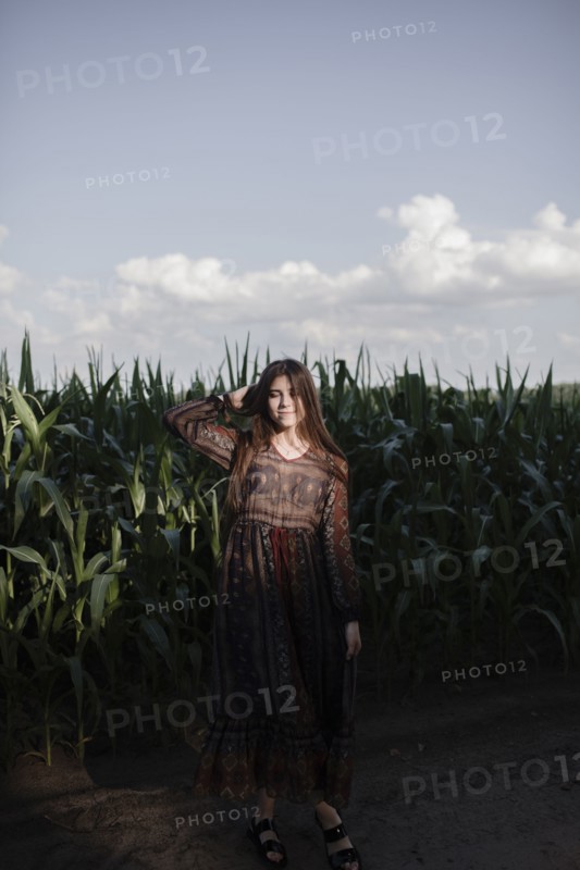 Caucasian woman standing in cornfield
