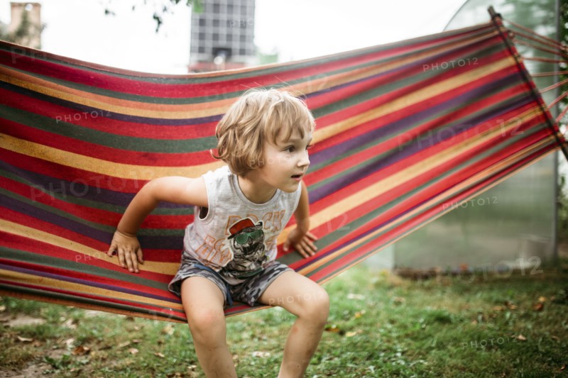 Caucasian boy sitting in hammock