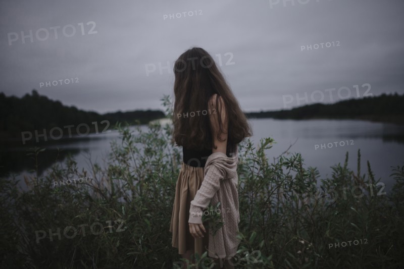 Caucasian woman standing near river