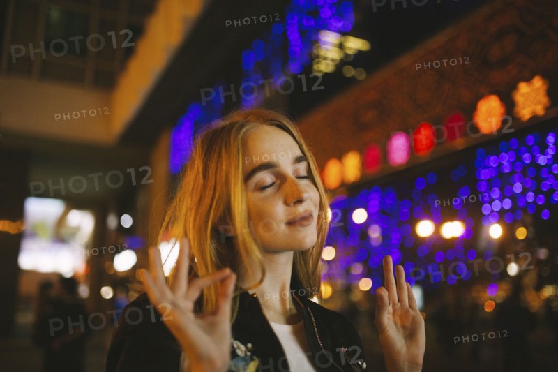 Caucasian woman listening to nightlife