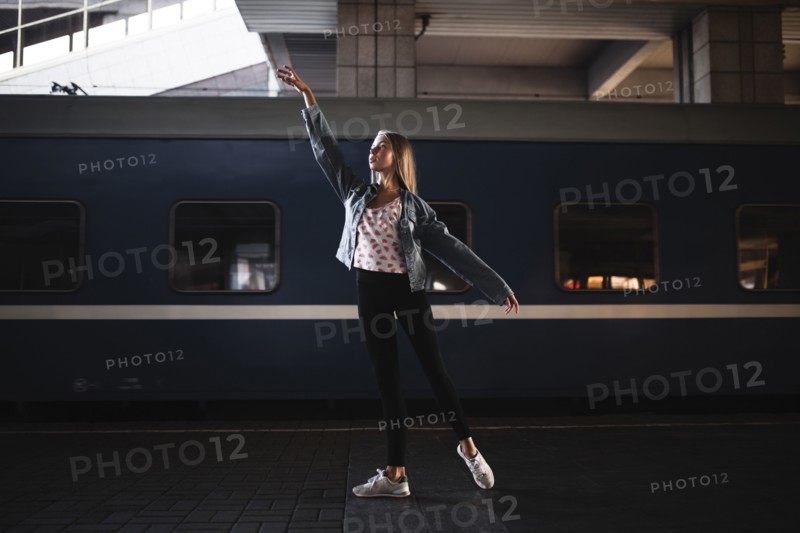Caucasian woman dancing near train