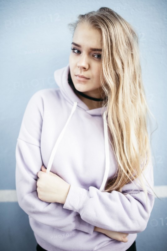 Portrait of serious Caucasian woman wearing hoodie