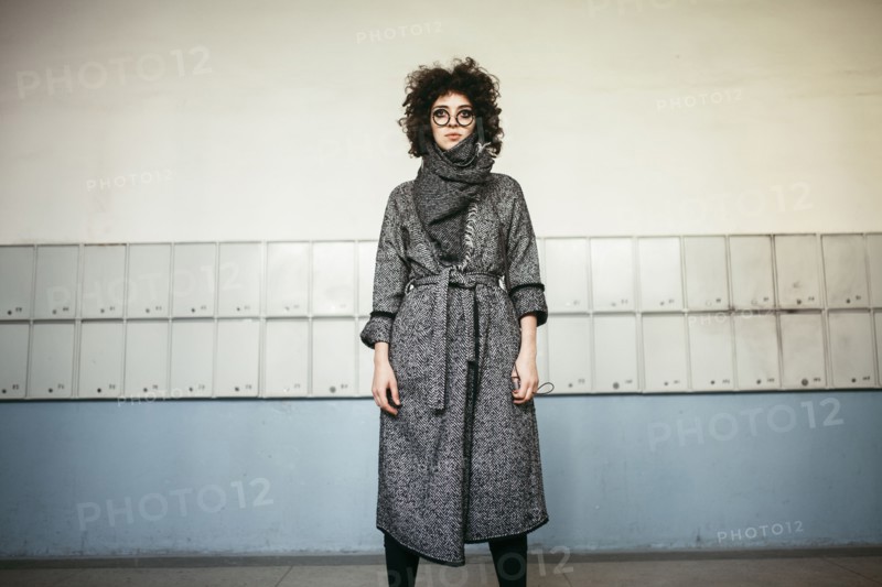 Serious Caucasian woman wearing scarf and coat