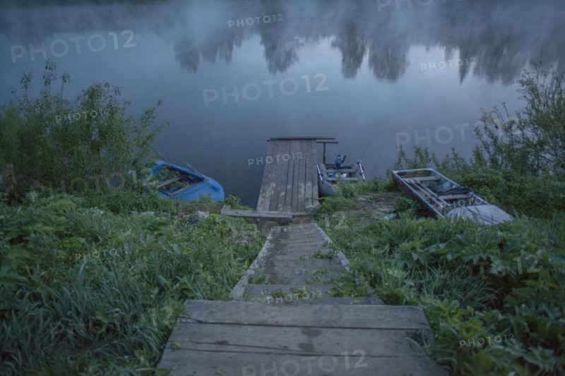 Wooden dock in still rural lake