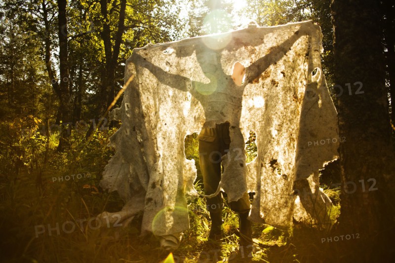 Caucasian man holding fabric outdoors