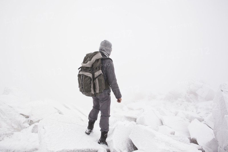 Caucasian man hiking in snow