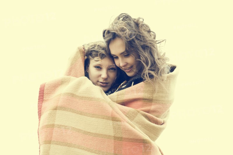 Caucasian women wrapped in blanket