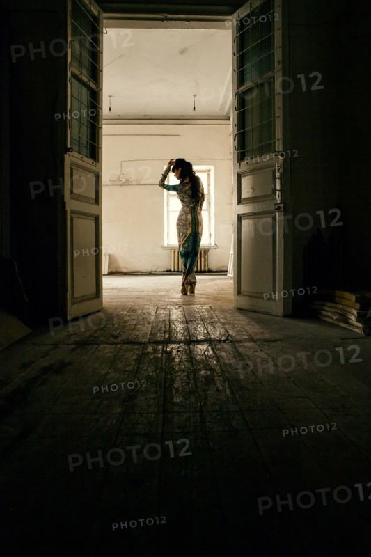 Caucasian woman standing in dilapidated house