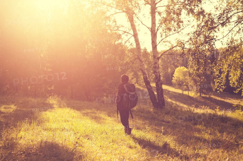 Mari man carrying backpack in rural field