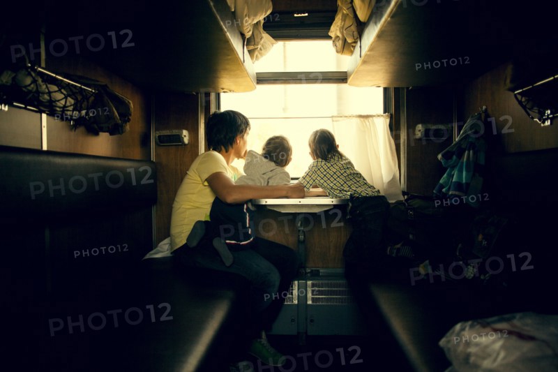 Father and children looking out trailer window
