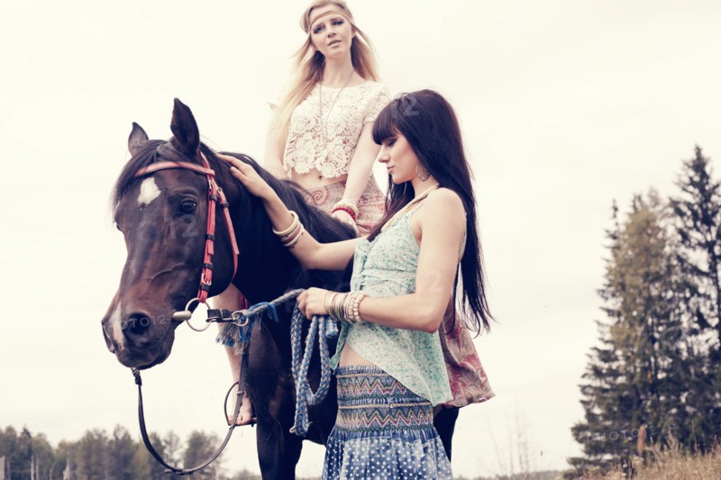 Caucasian women petting and riding horse outdoors