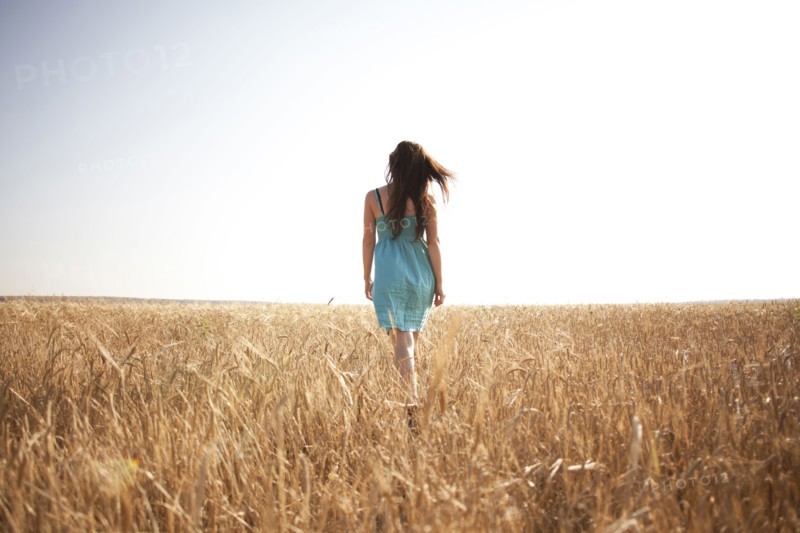 Caucasian woman walking in rural field