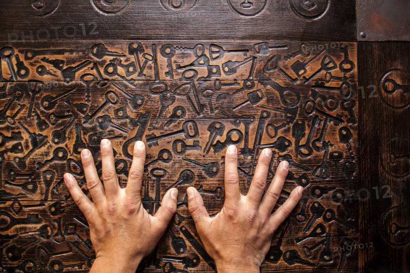 Close up of hands of Mari man hands on wooden surface