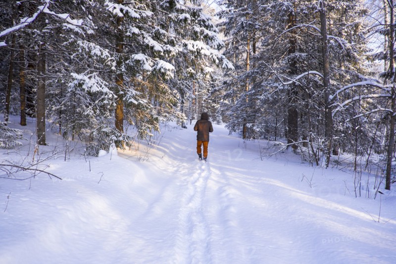 Mari boy walking in snowy field