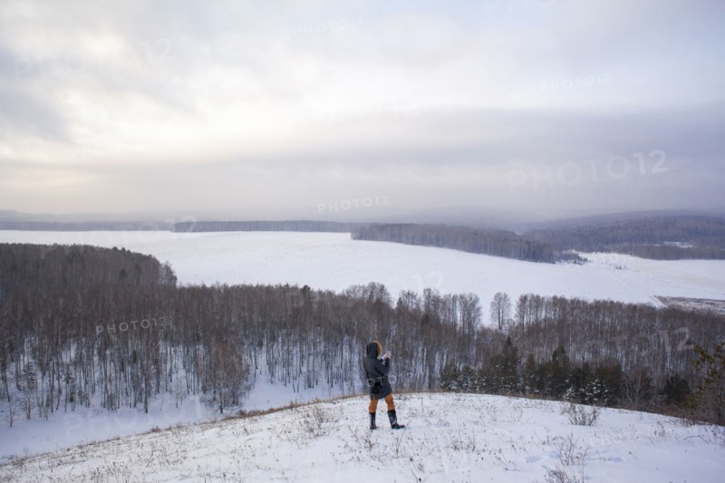 Caucasian woman standing on snowy hilltop