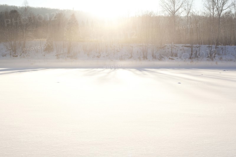 Sun shining over snowy field