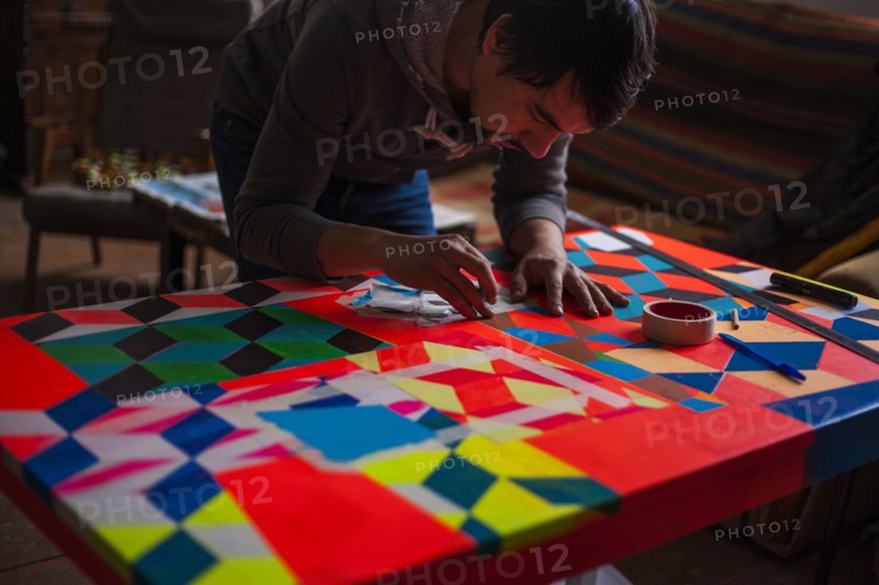 Mari man designing colorful table