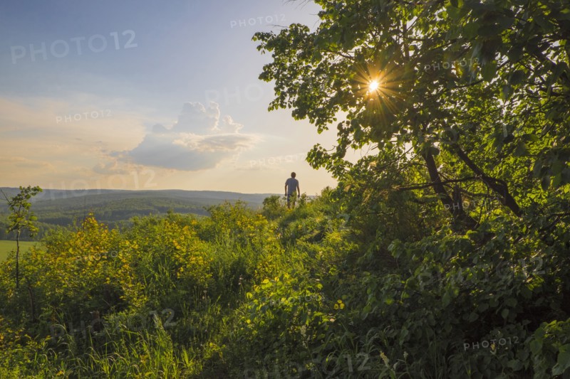 Mari man walking in rural landscape