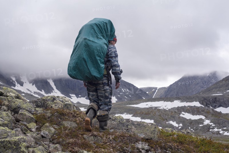 Mari backpacker walking on mountain path
