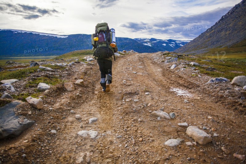 Mari backpacker walking on dirt path