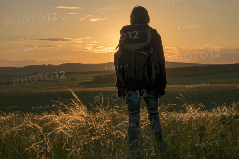 Caucasian woman admiring landscape at sunset