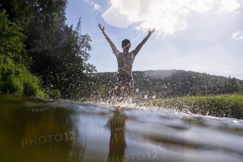Mari man splashing in lake