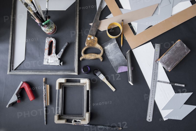 Picture frame and tools on table