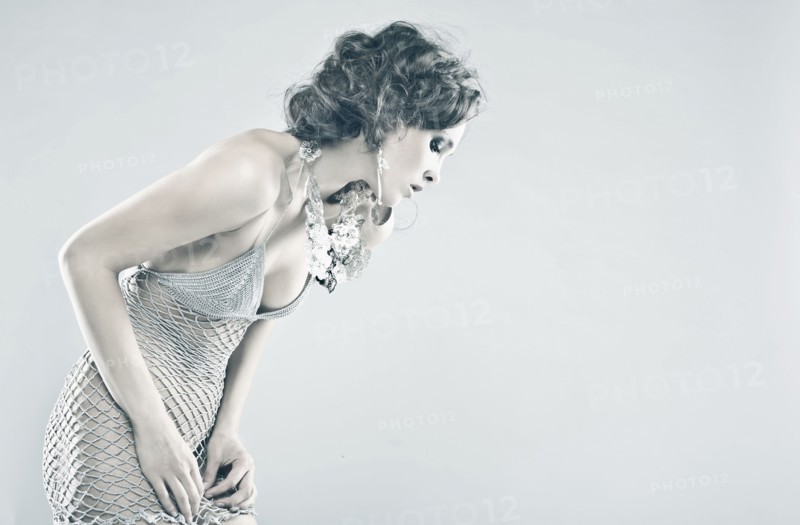 Curious Caucasian woman wearing sheer dress looking down