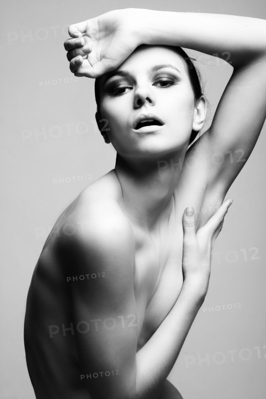 Portrait of serious naked Caucasian woman