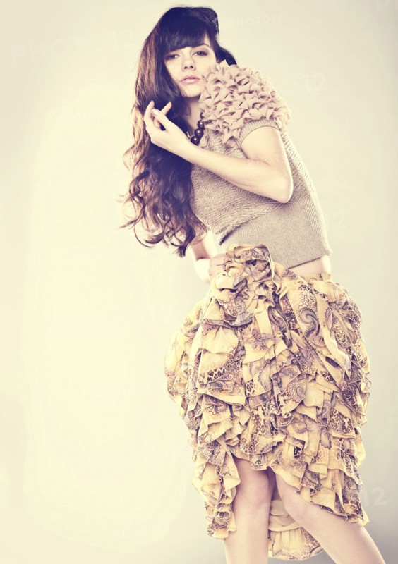 Serious Caucasian woman wearing ruffled skirt