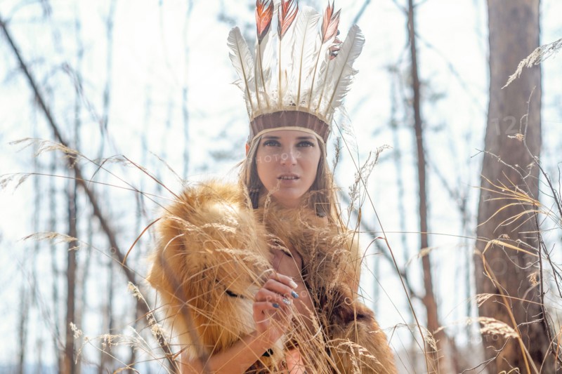 Caucasian woman wearing headdress in forest